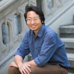 Soravis Prakkamakul sitting on steps in front of South Hall