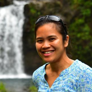 photo of Lea Cleary standing in front of a waterfall