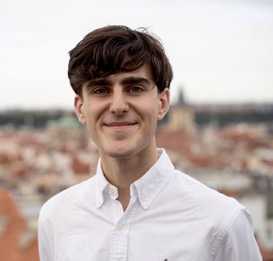 headshot of a man with white button up