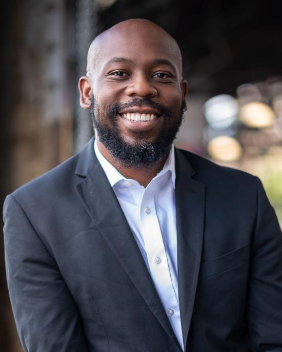 Man in blue suit smiling at camera