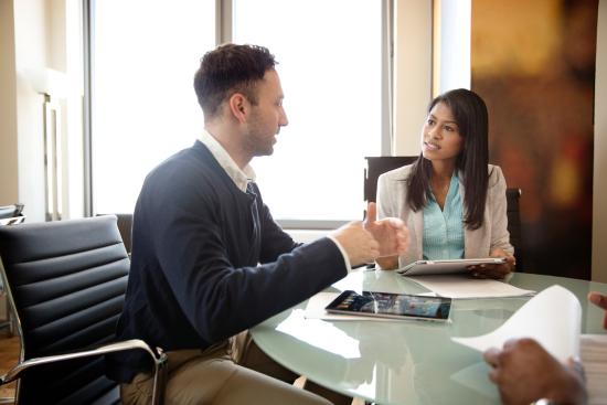 Photo of a man and a woman in a business meeting