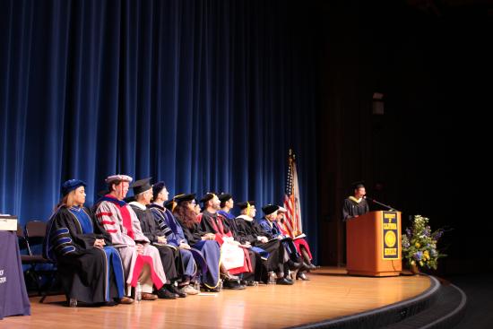 MIMS student Soravis Prakkamakul speaking at graduation