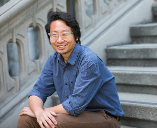 Soravis Prakkamakul sitting on steps in front of South Hall